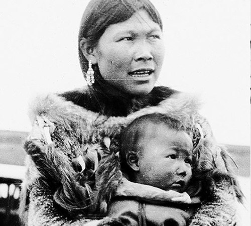Eskimo woman holding her baby