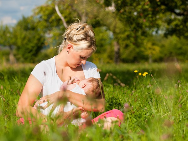Breastfeeding in a field of grass