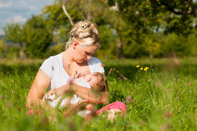 Breastfeeding in a field of grass