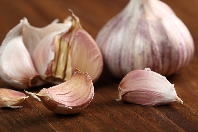 Garlic bulbs and cloves on wooden table