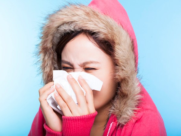 Woman blowing her nose