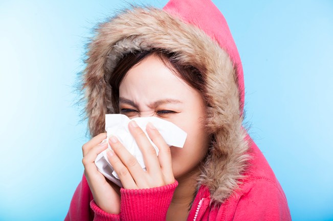 Woman blowing her nose